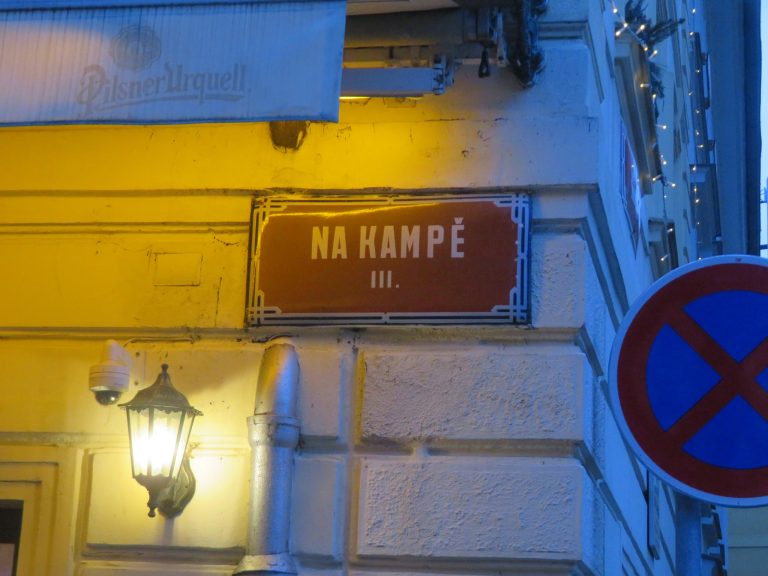 Old street sign on the side of a restaurant on Kampa