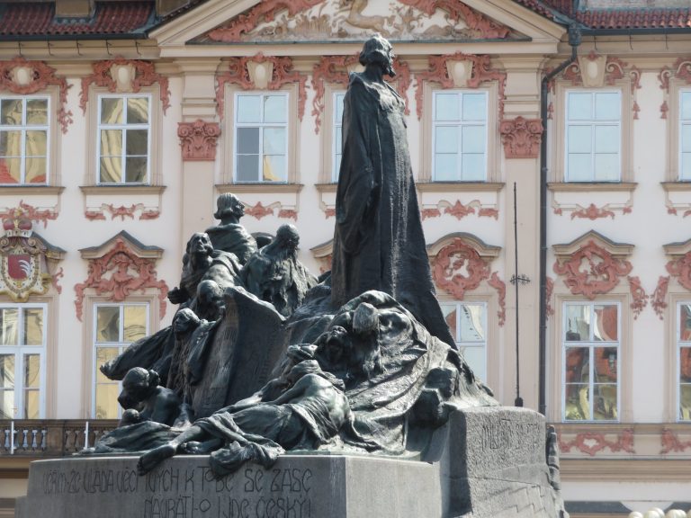 Sculpture of Jan Hus in front of the palace