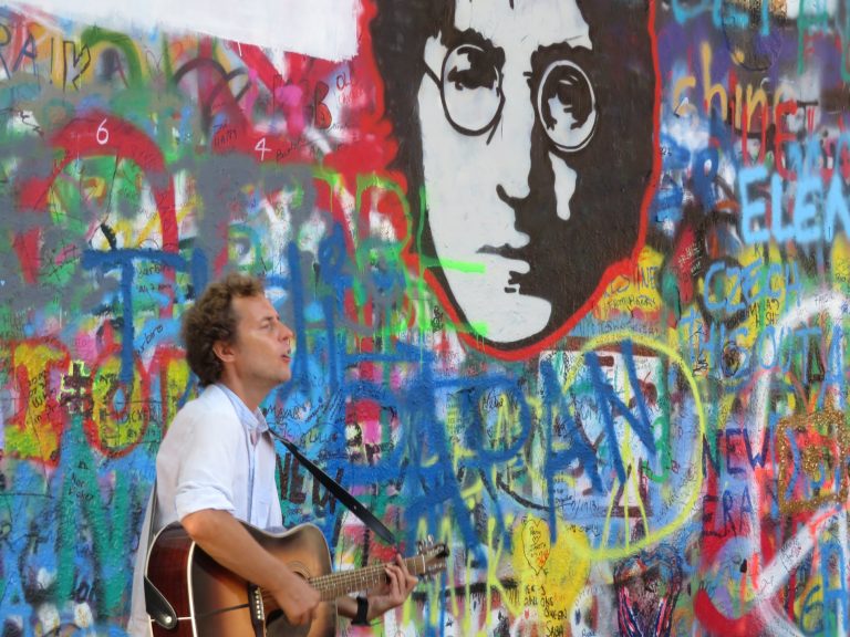 Street musician at the Lennon Wall