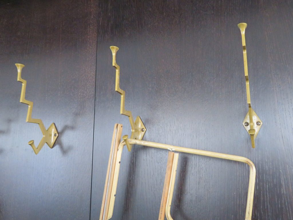 Cubist-style coat hooks and a newspaper rack